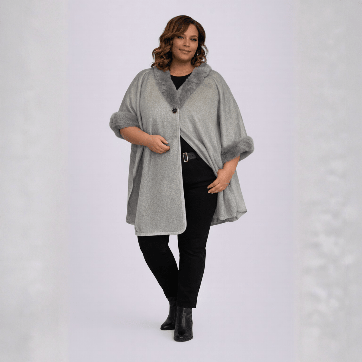 Gray cape with faux fur collar, featuring a button closure and stylish design.