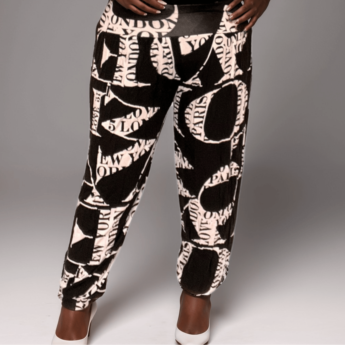 Fashionable black and white printed pants featuring city names like London and Paris.