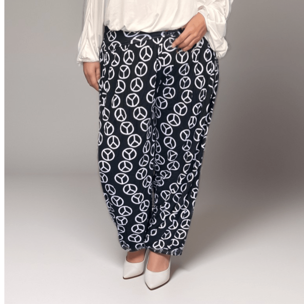 Peace Sign Pants featuring a navy background with white peace symbols, perfect for casual wear.